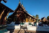 Wat Xieng Thong temple in Luang Prabang, Laos.  A view of the 'sim' with the large sweeping roof. 